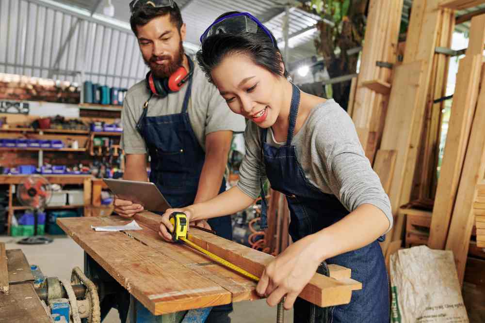 Two carpenter is making a furniture.