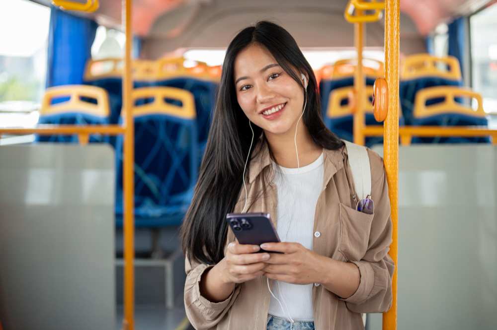 A smiling young woman in a Bus.